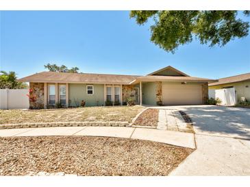 Charming single-story home featuring stone accents, a two-car garage, and a well-maintained lawn at 12532 115Th St, Largo, FL 33778