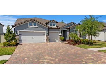 Charming single-Gathering home with a three car garage and brick paver driveway, situated in a well-kept neighborhood at 19204 Briarbrook Dr, Tampa, FL 33647