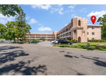 Charming condo building featuring unique architectural details and well-maintained landscaping at 2458 Columbia Dr E # 84, Clearwater, FL 33763