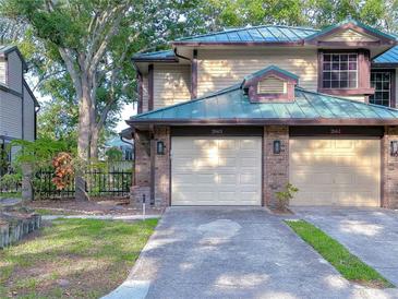 Inviting townhome featuring a well-manicured lawn and convenient two-car garage at 2663 Sequoia Ter # 2663, Palm Harbor, FL 34683