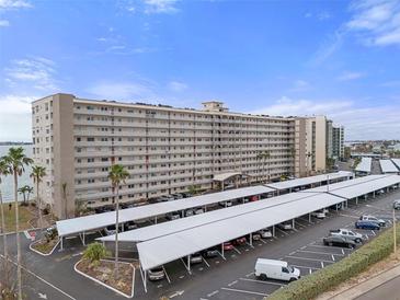 Stunning high-rise condo building featuring covered parking, mature landscaping and serene waterfront views at 5980 Shore S Blvd # 312, Gulfport, FL 33707