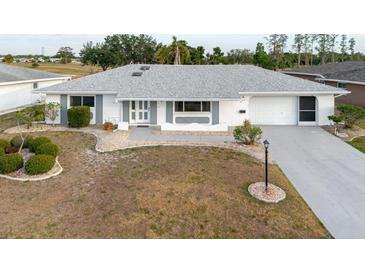 Charming single-story home featuring a well-maintained yard, neutral tones, and attached two-car garage at 646 Allegheny Dr, Sun City Center, FL 33573