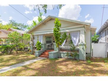 Charming single-story home with a welcoming front porch and lush landscaping at 1008 E 25Th Ave, Tampa, FL 33605