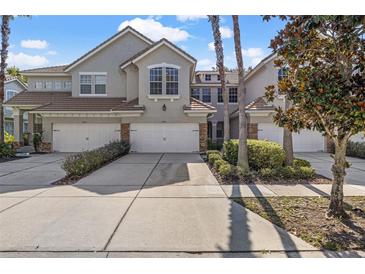 Charming townhomes with stone accents, three-car garages, and lush landscaping at 14418 Mirabelle Vista Cir, Tampa, FL 33626