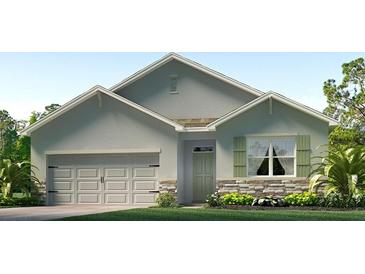 Charming single-Gathering home featuring a two-car garage, stone accents, and well-manicured lawn at 3525 Thistle Bank Ct, Plant City, FL 33565