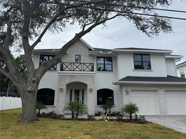 Stunning two-story home with white brick accents, black framed windows and a two-car garage at 3910 W San Carlos St, Tampa, FL 33629