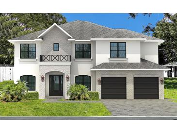 Elegant two-story home featuring stone accents, a gray roof, and a two-car garage with a beautiful lawn at 3910 W San Carlos St, Tampa, FL 33629