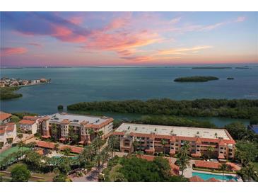 Beautiful coastal condos featuring red tile roofs, tropical landscaping, and stunning bay views at sunset at 1695 Pinellas Bayway S # E6, St Petersburg, FL 33715