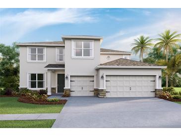 Inviting two-story home with a three-car garage, well-manicured landscaping, and classic design at 4030 Harvest Hearth Pl, Plant City, FL 33565
