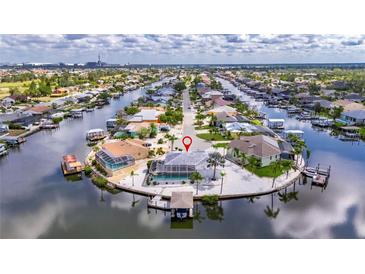 Stunning aerial view of waterfront property in a charming neighborhood with private boat dock and mature landscaping at 927 Golf Island Dr, Apollo Beach, FL 33572