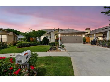 Charming single-story home featuring a well-manicured lawn, beautiful landscaping, and a spacious two-car garage at 1511 Woonsocket Ln, Brandon, FL 33511