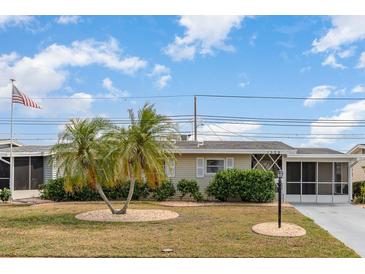 Charming single-story home featuring manicured landscaping and a welcoming facade at 1528 Chevy Chase Dr, Sun City Center, FL 33573