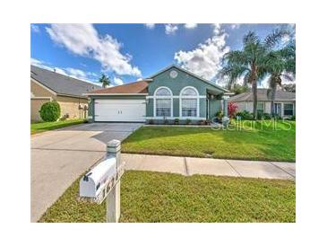 Charming single-story home with well-manicured lawn, driveway, and attached garage at 1624 Maximilian Dr, Wesley Chapel, FL 33543