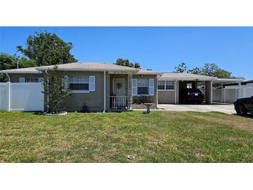 Charming single-story brick home featuring a well-maintained lawn and an attached carport at 2505 Minnehaha, Tampa, FL 33614