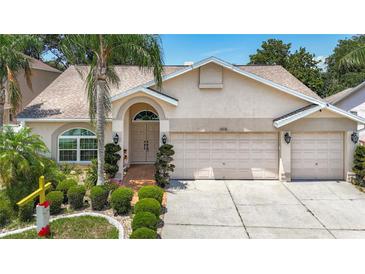 Charming single-story home featuring a well-manicured lawn and attached three car garage at 11216 Longbrooke Dr, Riverview, FL 33579