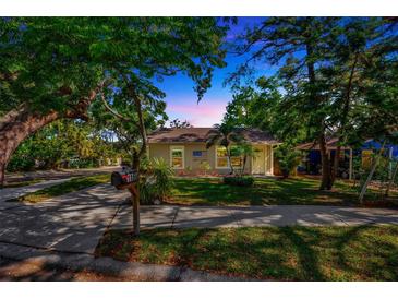 Charming home with a well-manicured lawn and mature trees offering shade and curb appeal at 1155 Withlacoochee St, Safety Harbor, FL 34695