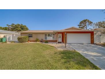 Charming single-story home with a well-maintained lawn, neutral exterior, and attached two-car garage at 13057 89Th Ave, Seminole, FL 33776