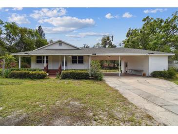 Charming home featuring a covered carport, and well-maintained lawn and landscaping at 2231 Nichols Rd, Lithia, FL 33547