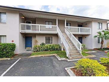 A multi-story condo building with exterior stairs and well-maintained landscaping at 3706 Greenery Ct # 206, Tampa, FL 33618