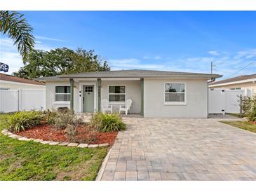 Charming single-story home featuring a well-manicured front yard and a paver driveway and a pleasing front entrance at 4003 W Lemon St, Tampa, FL 33609