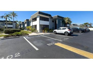 Condominium featuring screened balconies, well-maintained landscaping, and plenty of parking spaces at 5509 Fountain Lake Cir # C209, Bradenton, FL 34207