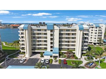 Multi-story condominium building boasting beautiful architecture, well-manicured landscaping, and convenient parking at 7872 Sailboat Key S Blvd # 602, South Pasadena, FL 33707