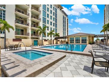 Beautiful community pool and spa area with lounge seating and lush landscaping at 1238 E Kennedy Blvd # 702, Tampa, FL 33602