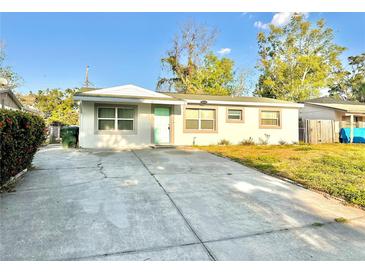 Charming single-story home featuring a well-maintained front yard and a welcoming entrance with a quaint, colored door at 13649 120Th St, Largo, FL 33778