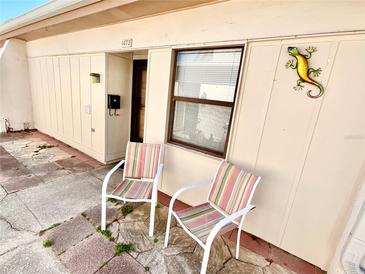 Inviting home exterior showcasing a cozy patio area with chairs and decorative accents at 1473 Feather Dr # 1473, Clearwater, FL 33759