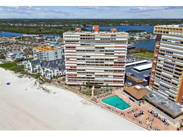 Expansive aerial view of the condominium building with a swimming pool and beach access at 17940 Gulf Blvd # 9B, Redington Shores, FL 33708