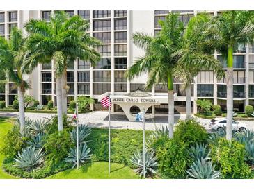Beautifully landscaped Monte Carlo Towers with palm trees, lush greenery, and a welcoming entrance at 3301 Bayshore Blvd # 2401E, Tampa, FL 33629