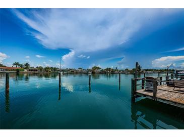 Beautiful waterfront view with dock and bright blue skies, offering a serene and picturesque setting at 333 Island Way # 203, Clearwater Beach, FL 33767