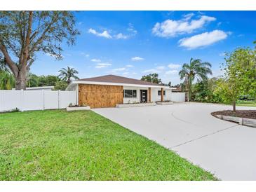 Charming single-story home with modern wood accents, manicured lawn, and a circular driveway at 4500 22Nd N Ave, St Petersburg, FL 33713