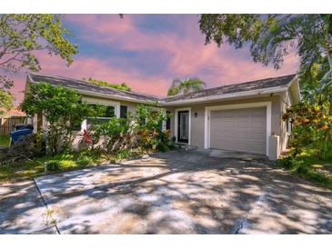 Charming home featuring a well-kept lawn, mature landscaping, and a one-car garage, creating inviting curb appeal at 503 Tangerine Dr, Oldsmar, FL 34677