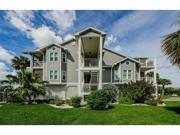 Attractive multi-story condo building featuring well-maintained landscaping and inviting staircases at 5712 Biscayne Ct # 205, New Port Richey, FL 34652