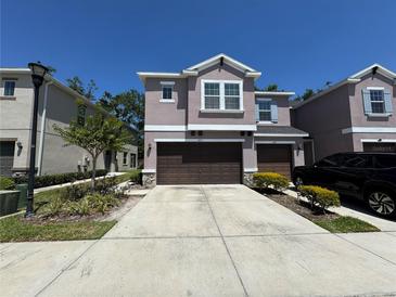 Charming two-story townhome with a two-car garage and well-maintained landscaping at 6617 Citrus Creek Ln, Tampa, FL 33625