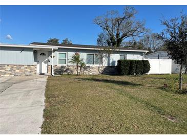 Charming single-story home with a stone accent wall and well-maintained lawn at 7503 N Howard Ave, Tampa, FL 33604