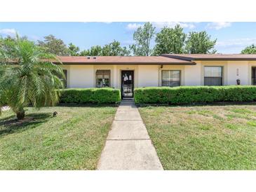 Inviting one-story home with a well-manicured lawn, trimmed hedges, and a welcoming entrance at 11511 113Th St # 35E, Largo, FL 33778