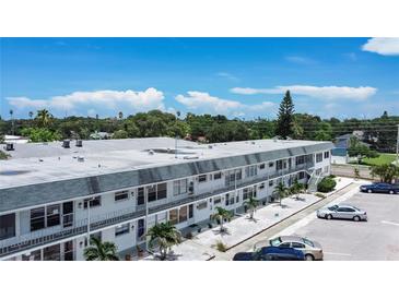 Two-story condo with well-maintained landscaping and ample parking on a bright, sunny day at 1221 Drew St # B17, Clearwater, FL 33755