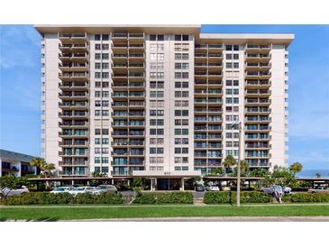 Luxury high-rise condo building featuring multiple stories, balconies, and covered parking at 400 Island Way # 210, Clearwater Beach, FL 33767