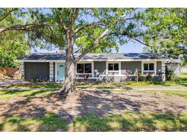 Charming single-story home with a tidy front yard and mature landscaping under a bright blue sky at 401 Patica Ne Rd, St Petersburg, FL 33702