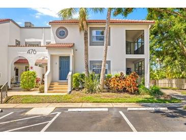 Charming two-story condo featuring lush landscaping, a private entrance, and ample parking at 476 Santa Cruz Ne Pl # C, St Petersburg, FL 33703
