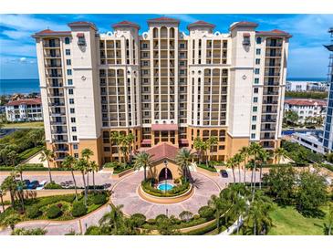 Stunning exterior view of a luxurious high-rise condo building with elegant architecture and lush landscaping at 5823 Bowen Daniel Dr # 606, Tampa, FL 33616