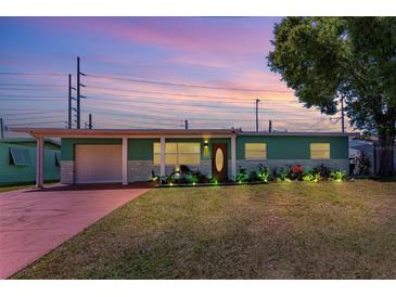 Charming single-story home featuring a well-manicured lawn, landscaping, and a cozy, inviting entrance at 7530 85Th Ln, Seminole, FL 33777