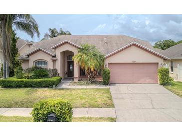 Charming single-story home featuring well-manicured landscaping and a two-car garage at 9327 Pontiac Dr, Tampa, FL 33626