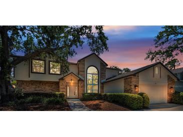 Charming home featuring a well-manicured lawn, brick accents, and a large window at 962 Marco Ne Dr, St Petersburg, FL 33702