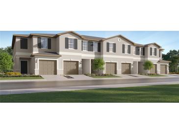 Charming townhome exterior showcasing a well-maintained lawn and inviting curb appeal at 36046 Risa Michele St, Zephyrhills, FL 33541