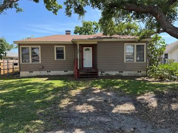 Charming single-story home featuring a cozy front porch and a well-maintained front yard under a shady tree at 536 89Th N Ave, St Petersburg, FL 33702