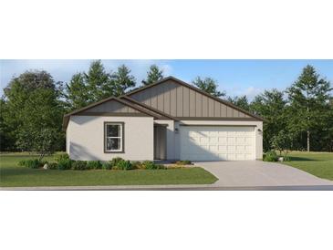 Charming single-story home featuring stucco siding, a two-car garage, and well-maintained landscaping at 5632 Red Kite Dr, Wimauma, FL 33598