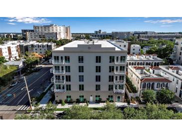 Modern condo building featuring a neutral color palette, multiple balconies, and well-maintained landscaping at 600 3Rd S Ave # 201, St Petersburg, FL 33701